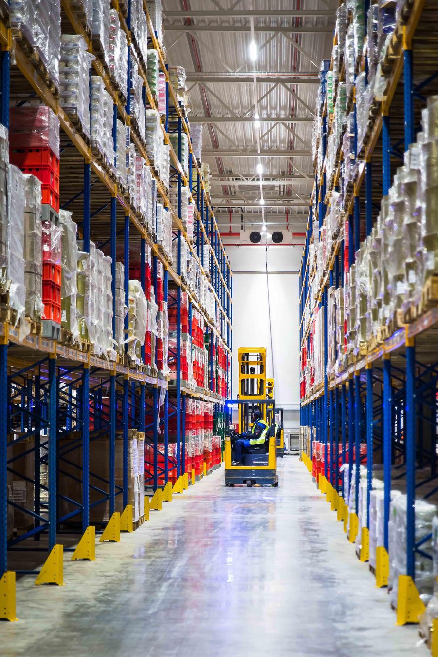 MPIO warehouse aisle with forklift operator moving inventory
